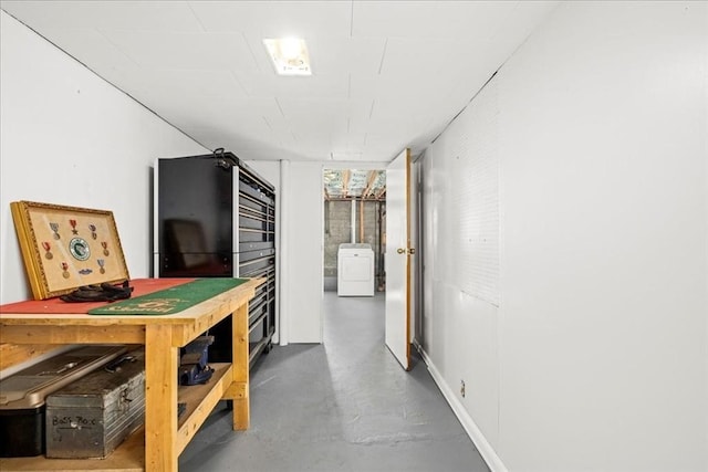 hall with concrete flooring and washer / clothes dryer