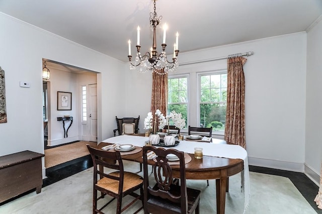 dining space featuring crown molding, a chandelier, and baseboards