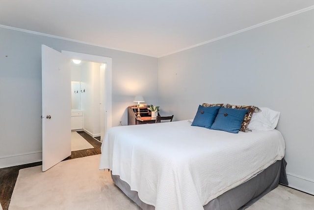 bedroom featuring crown molding, baseboards, and wood finished floors