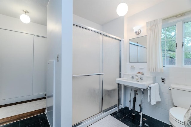 full bath with toilet and a shower stall