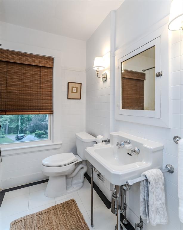 bathroom featuring tile walls, toilet, and tile patterned flooring