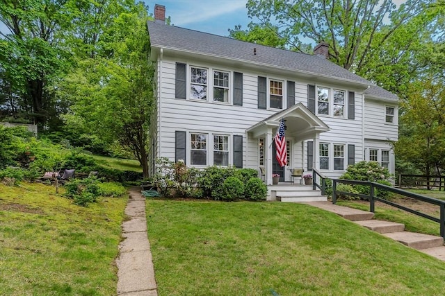 colonial-style house featuring a chimney