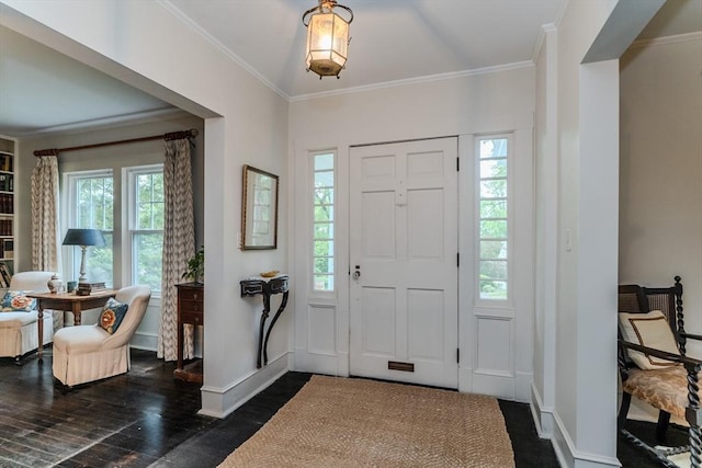 entrance foyer with plenty of natural light, crown molding, dark wood finished floors, and baseboards