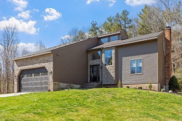 mid-century home featuring concrete driveway, a chimney, stone siding, a front lawn, and an attached garage