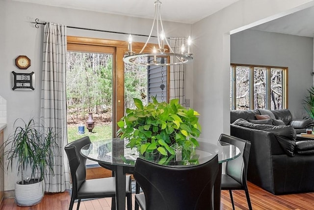 dining area with a chandelier and wood finished floors