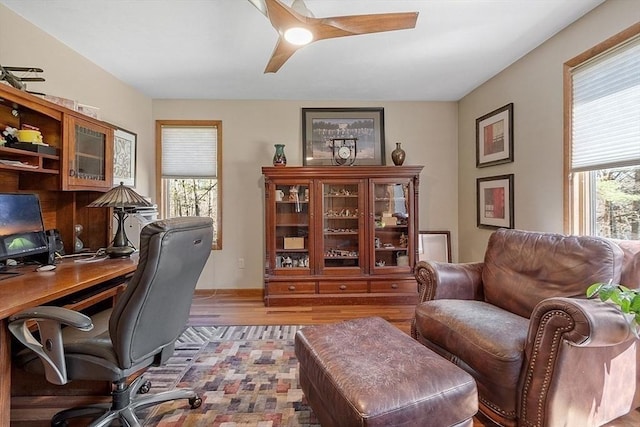 office with wood finished floors, a ceiling fan, and a wealth of natural light