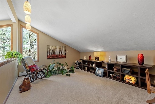 interior space featuring a textured ceiling, lofted ceiling with beams, carpet, and a baseboard radiator