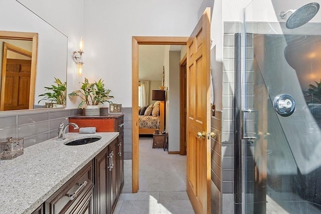 bathroom with a shower stall, ensuite bathroom, vanity, and decorative backsplash