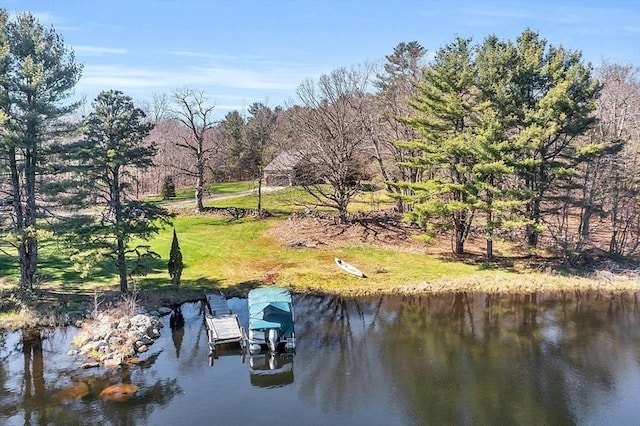 view of dock featuring a water view and a yard