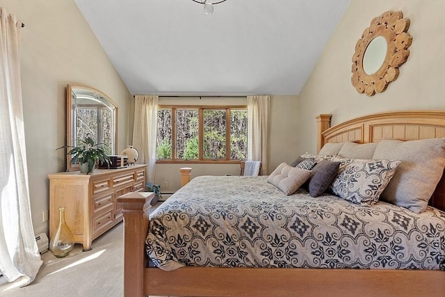 bedroom with light colored carpet and vaulted ceiling