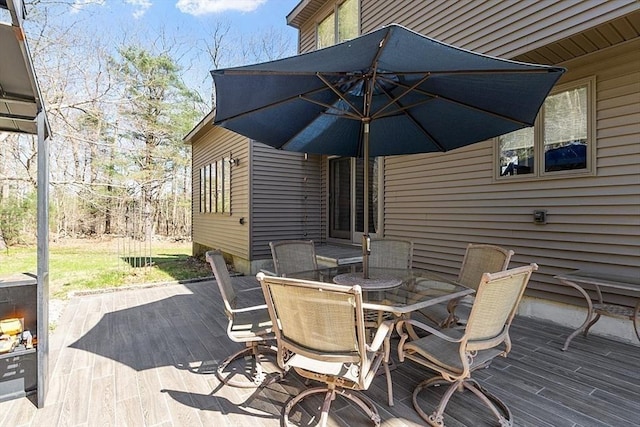 view of patio with outdoor dining space and a deck