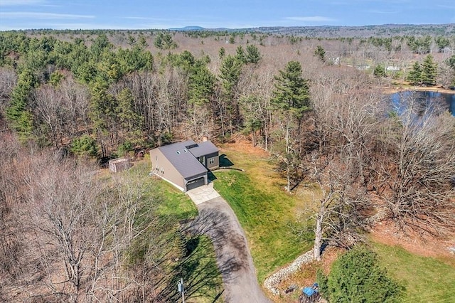 drone / aerial view with a view of trees and a water view