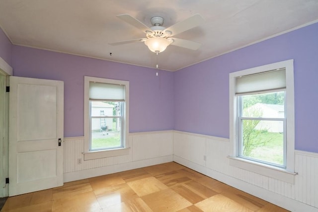 28 River St, Erving, MA 01344 - spare room with wainscoting, a ceiling fan, and ornamental molding