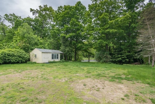 28 River St, Erving, MA 01344 - view of grassy yard featuring an outdoor structure and a forest view