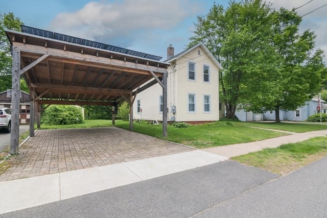 28 River St, Erving, MA 01344 - view of front of home featuring a chimney, a front yard, and a carport
