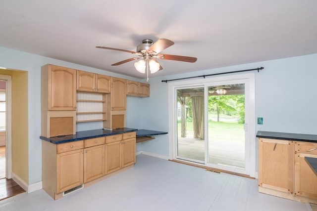 28 River St, Erving, MA 01344 - kitchen with light brown cabinetry, ceiling fan, baseboards, light wood finished floors, and dark countertops