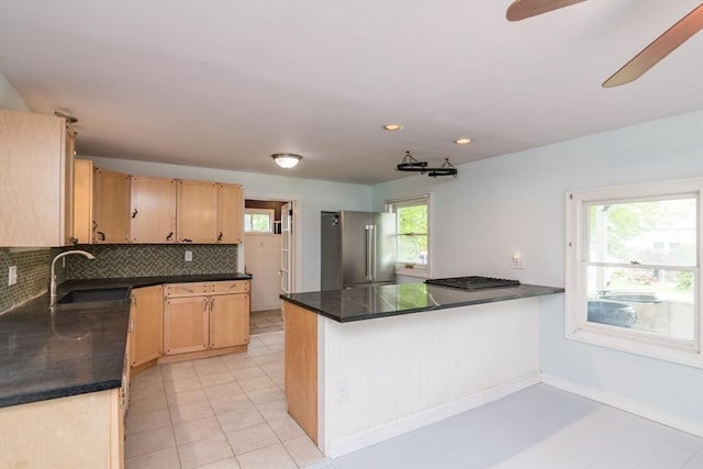 28 River St, Erving, MA 01344 - kitchen featuring high quality fridge, a sink, dark countertops, tasteful backsplash, and light brown cabinetry
