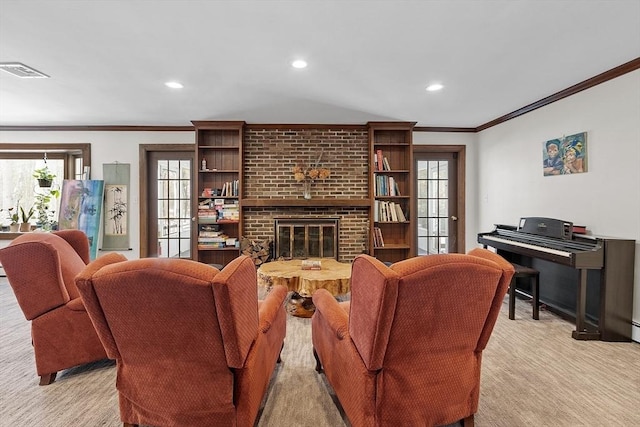 living room featuring crown molding, recessed lighting, visible vents, and a fireplace