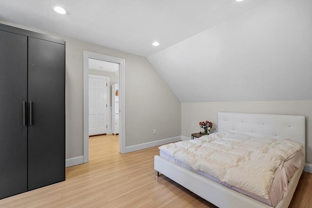 bedroom with light wood-style floors, lofted ceiling, baseboards, and recessed lighting