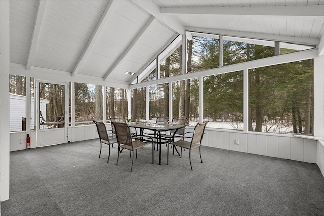 unfurnished sunroom with plenty of natural light and vaulted ceiling with beams