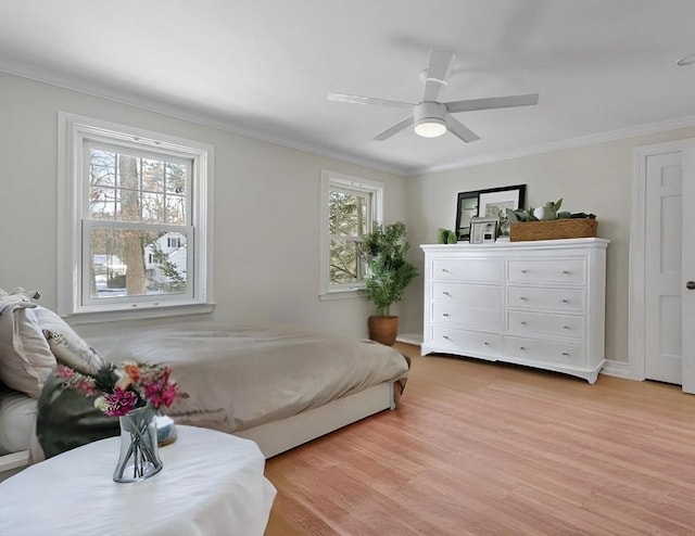 bedroom with light wood-type flooring, crown molding, and ceiling fan