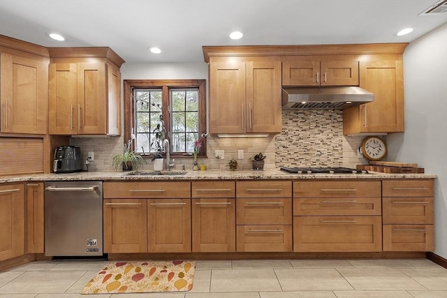 kitchen with light stone counters, under cabinet range hood, a sink, visible vents, and stainless steel gas stovetop