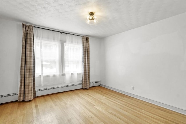 20 Marjorie Rd, Wilmington, MA 01887 - empty room with light wood-type flooring, baseboards, and a textured ceiling