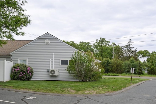 61 Outer Dr Unit 61, Chicopee, MA 01022 - view of side of property featuring ac unit, a lawn, and roof with shingles