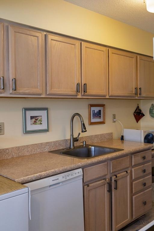 61 Outer Dr Unit 61, Chicopee, MA 01022 - kitchen with white dishwasher, a sink, and light countertops