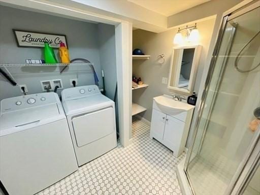laundry area with light floors, washer and clothes dryer, a sink, and laundry area