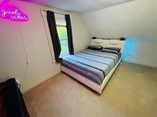 carpeted bedroom featuring lofted ceiling