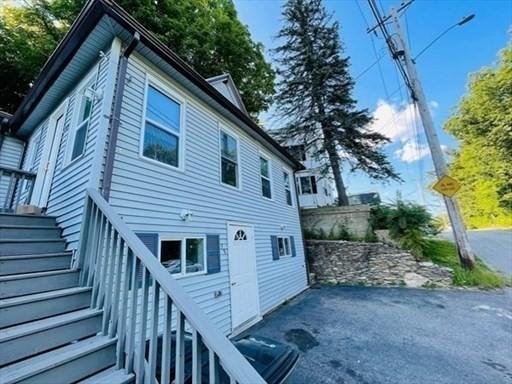 view of side of property with a patio and stairway