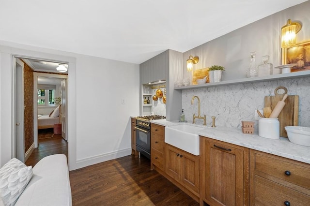 93 Pinckney Unit 1, Boston, MA 02114 - kitchen with a sink, gas stove, open shelves, dark wood-style floors, and brown cabinets