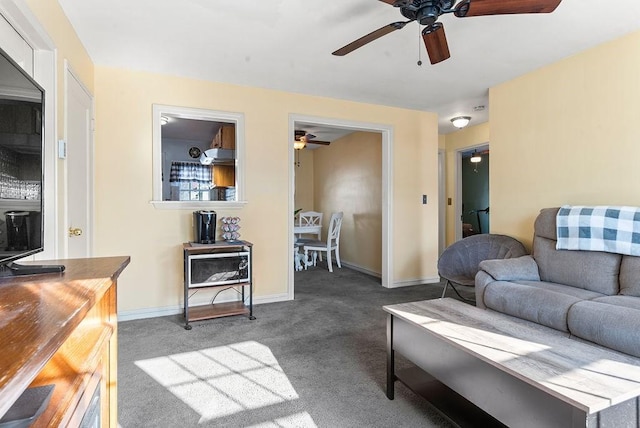 carpeted living room with ceiling fan