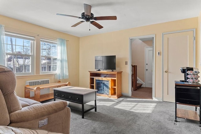 carpeted living room with ceiling fan