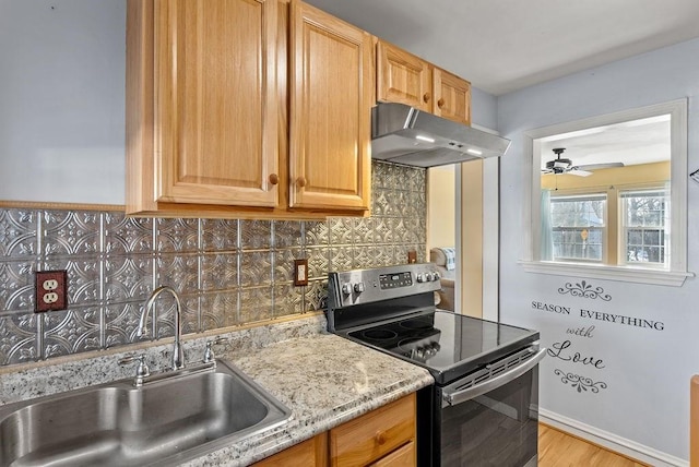 kitchen with sink, ceiling fan, electric range, tasteful backsplash, and light stone counters