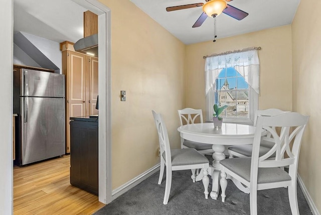 dining space featuring light hardwood / wood-style floors and ceiling fan