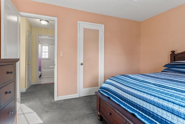 bedroom with connected bathroom and light colored carpet