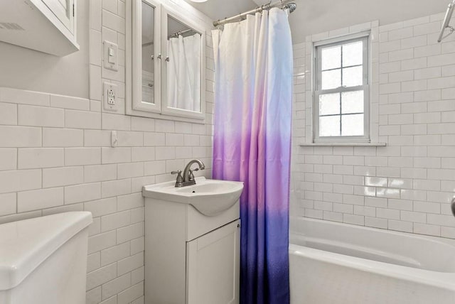 full bathroom featuring tile walls, vanity, toilet, and shower / bathtub combination with curtain