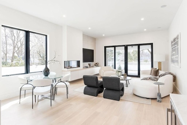 living room featuring french doors, recessed lighting, and light wood finished floors