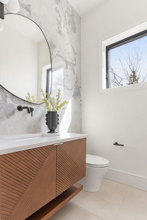 bathroom featuring tile patterned floors, toilet, and vanity