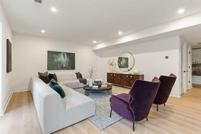 living area featuring recessed lighting, wood finished floors, and visible vents