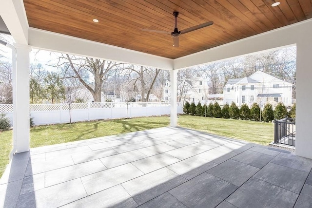 view of patio featuring ceiling fan and fence