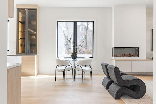 sitting room featuring baseboards and light wood-style floors