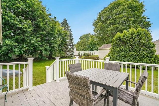 177 Elm St, Andover, MA 01810 - wooden terrace featuring outdoor dining area, a lawn, and an outbuilding