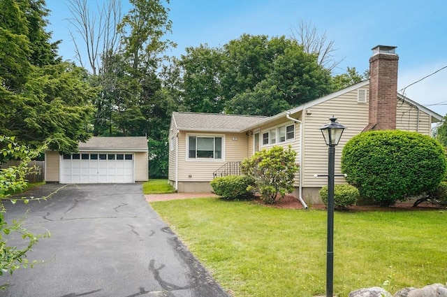 177 Elm St, Andover, MA 01810 - view of front of house with an outbuilding, a garage, a front lawn, and a chimney