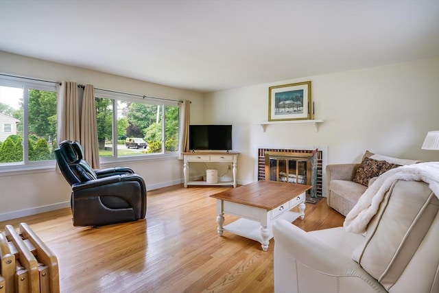 177 Elm St, Andover, MA 01810 - living room with plenty of natural light, light wood-style floors, radiator, and a brick fireplace
