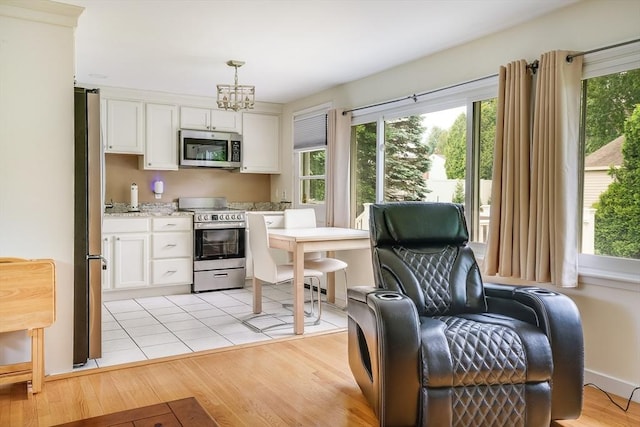 177 Elm St, Andover, MA 01810 - kitchen with stainless steel appliances, white cabinets, and light wood-style flooring