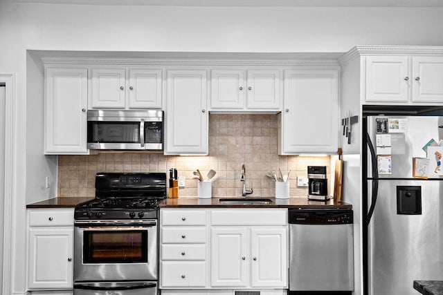 kitchen with a sink, white cabinetry, appliances with stainless steel finishes, and tasteful backsplash