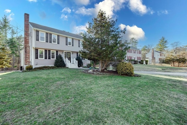 colonial inspired home with a front lawn